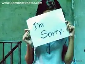 I am Sorry - Girl hiding face behind board